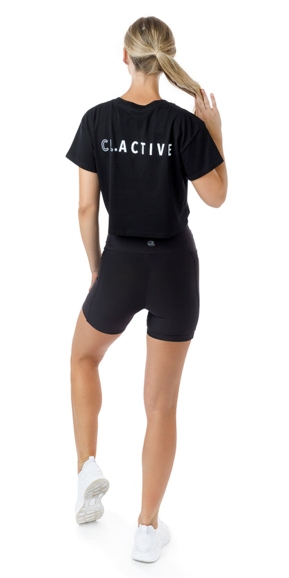 Full body rear view of girl in black Midnight CL Active Crop Tee and matching shorts