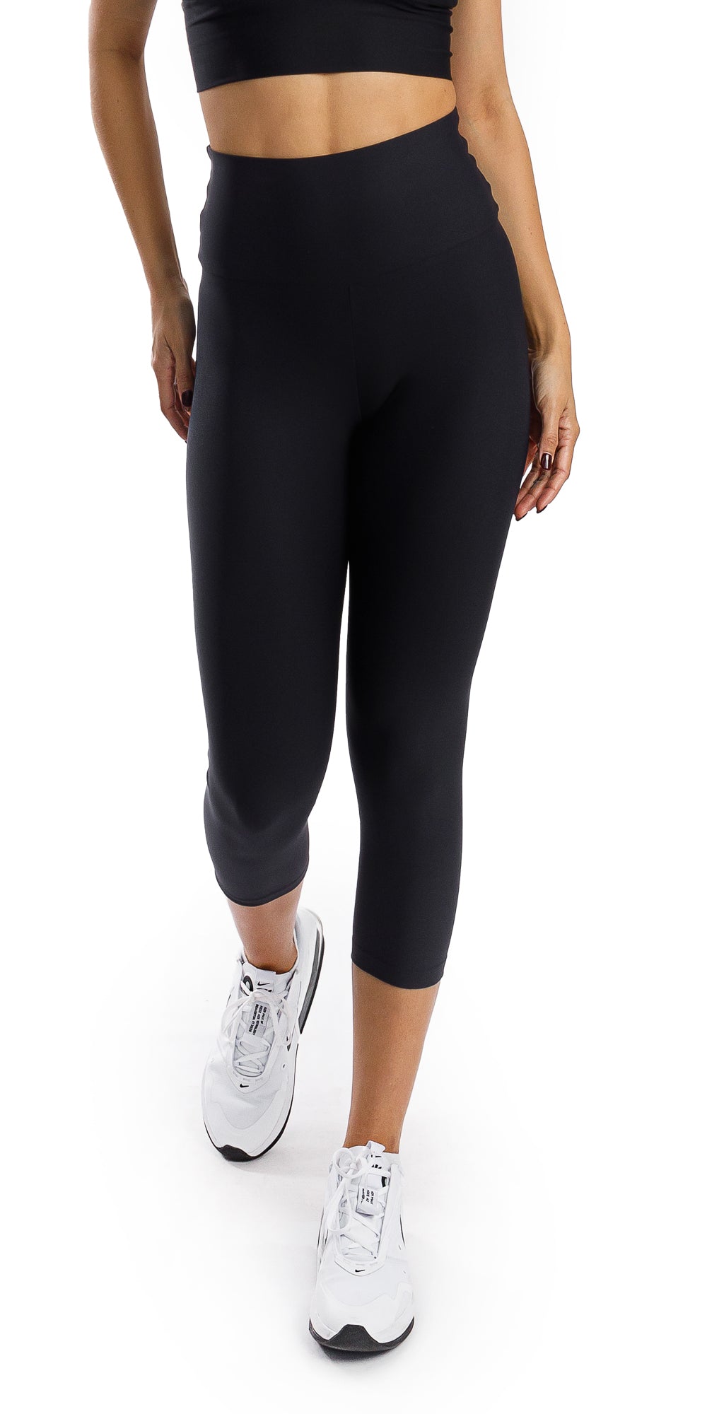 Front view of girl in black Midnight Eco Capri Leggings walking