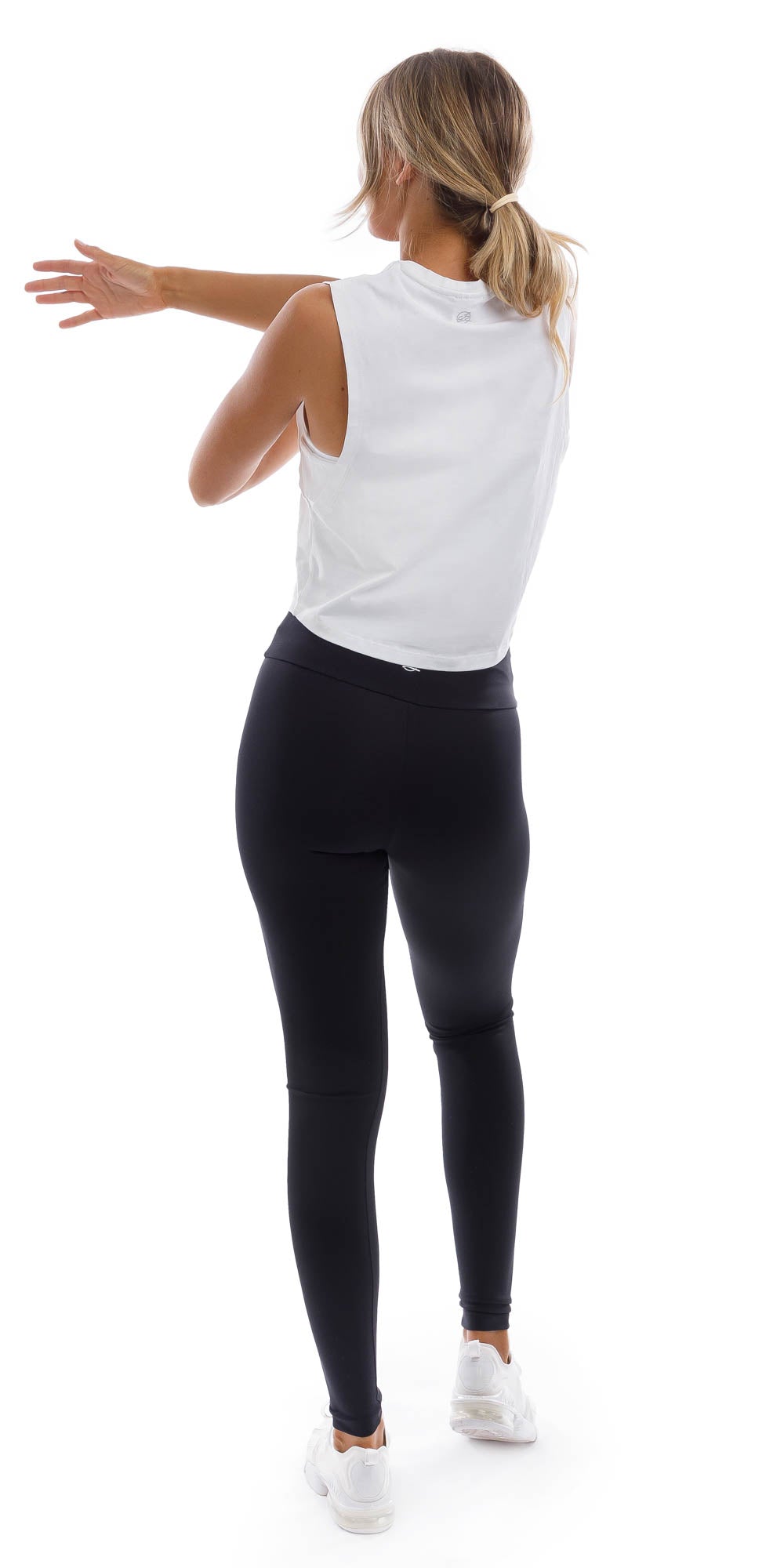Rear view of girl wearing cropped white Burleigh Tank with side straps & matching ultra high waist midnight leggings
