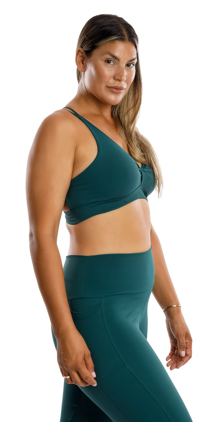 Side view of lady in coloured Teal Body Luxe Diamond Back Bra and matching bottoms looking aside while putting one leg forward