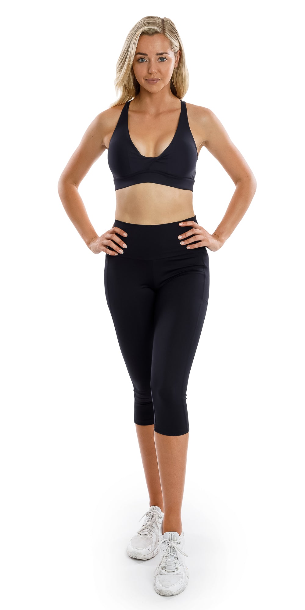 Full body front view of girl in black Midnight Eco Diamond Back Bra and matching bottoms putting both hands on waist