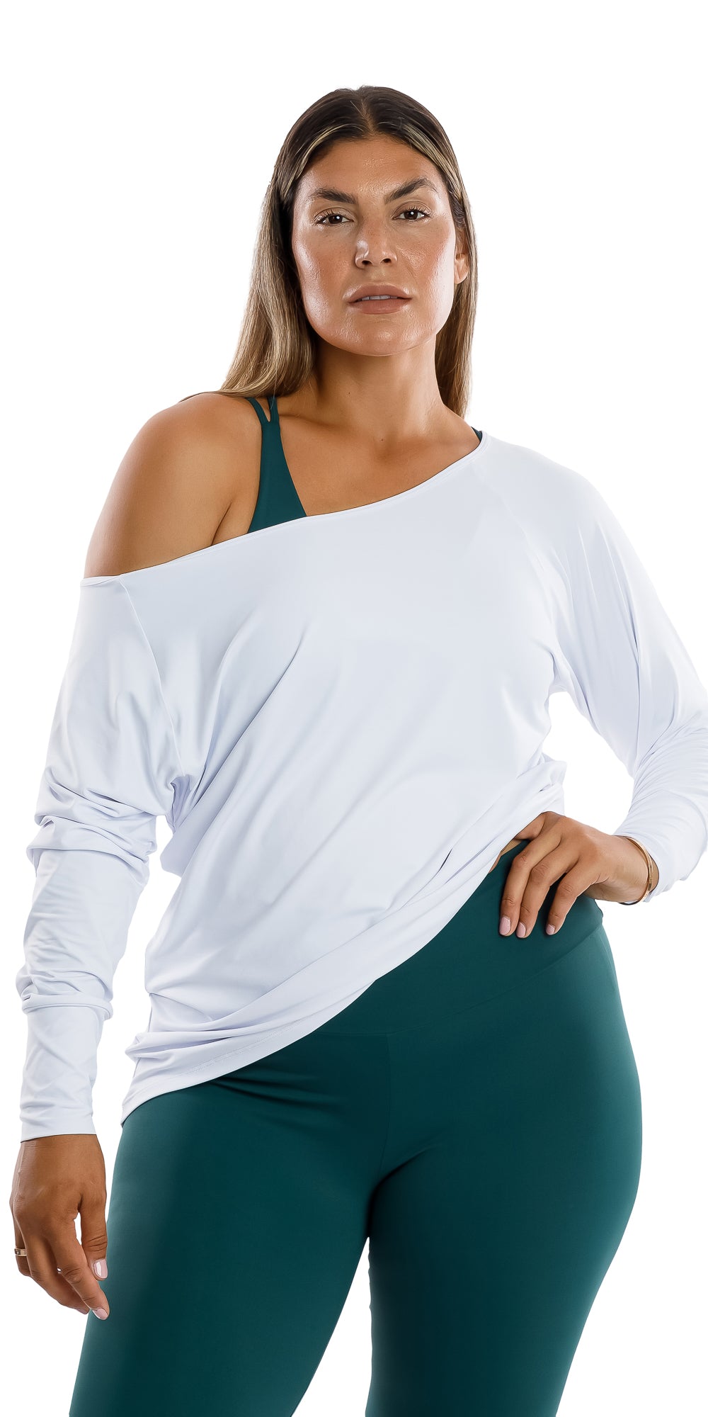 Front view of lady in White Off The Shoulder Long Sleeve Tee and teal coloured leggings putting left hand on waist