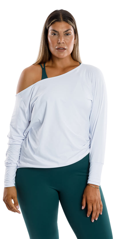 Front view of lady in White Off The Shoulder Long Sleeve Tee leaning on one leg and putting left hand on lap