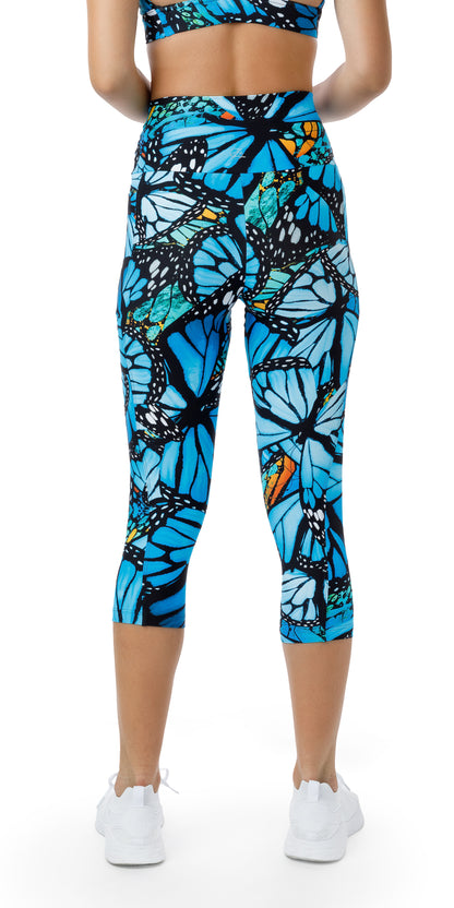 Rear view of girl in blue animal print JH Butterfly Eco Capri Leggings with Pockets