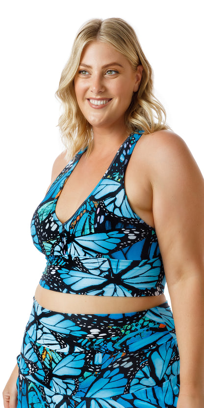 Side view of a smiling girl wearing blue animal print JH Butterfly Racer Back Bra and matching bottom