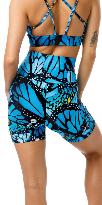 Rear view of girl in blue animal print JH Butterfly Midi Shorts with Pockets and matching bra