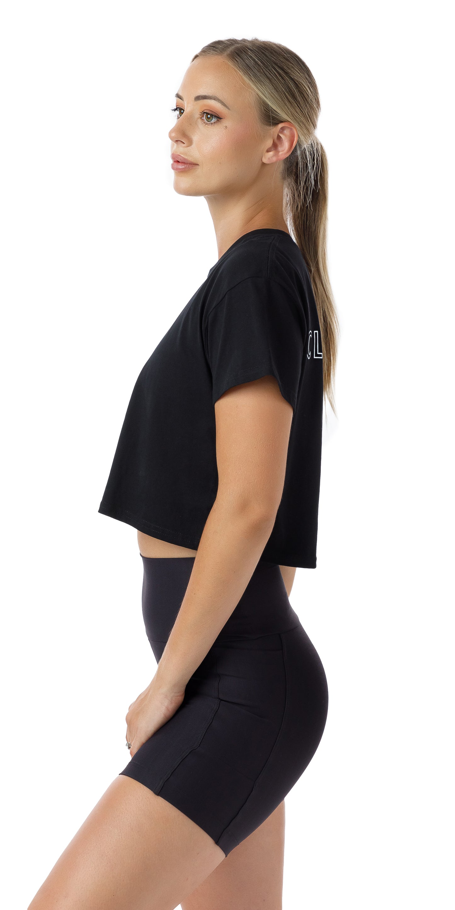 Side view of girl in black Midnight CL Active Crop Tee and matching shorts