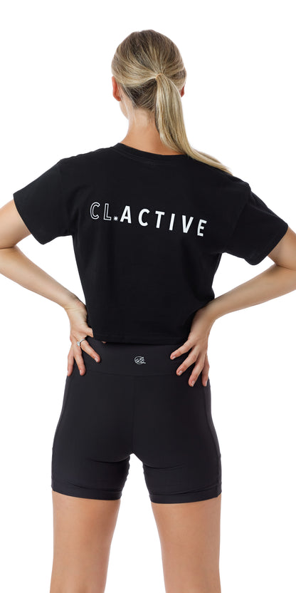 Rear view of girl in black Midnight CL Active Crop Tee putting both hands on waist