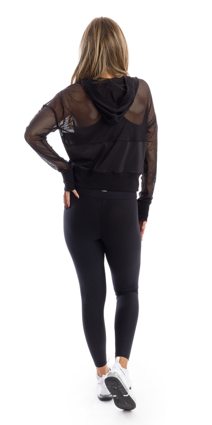 Full body rear view of girl in black Midnight Meshed Hoody and black leggings putting one hand on waist