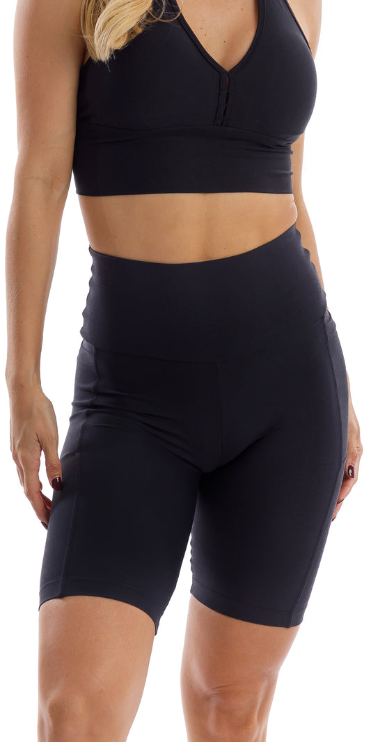 Front view of girl in black Midnight Eco Biker Shorts with Pockets and matching bra