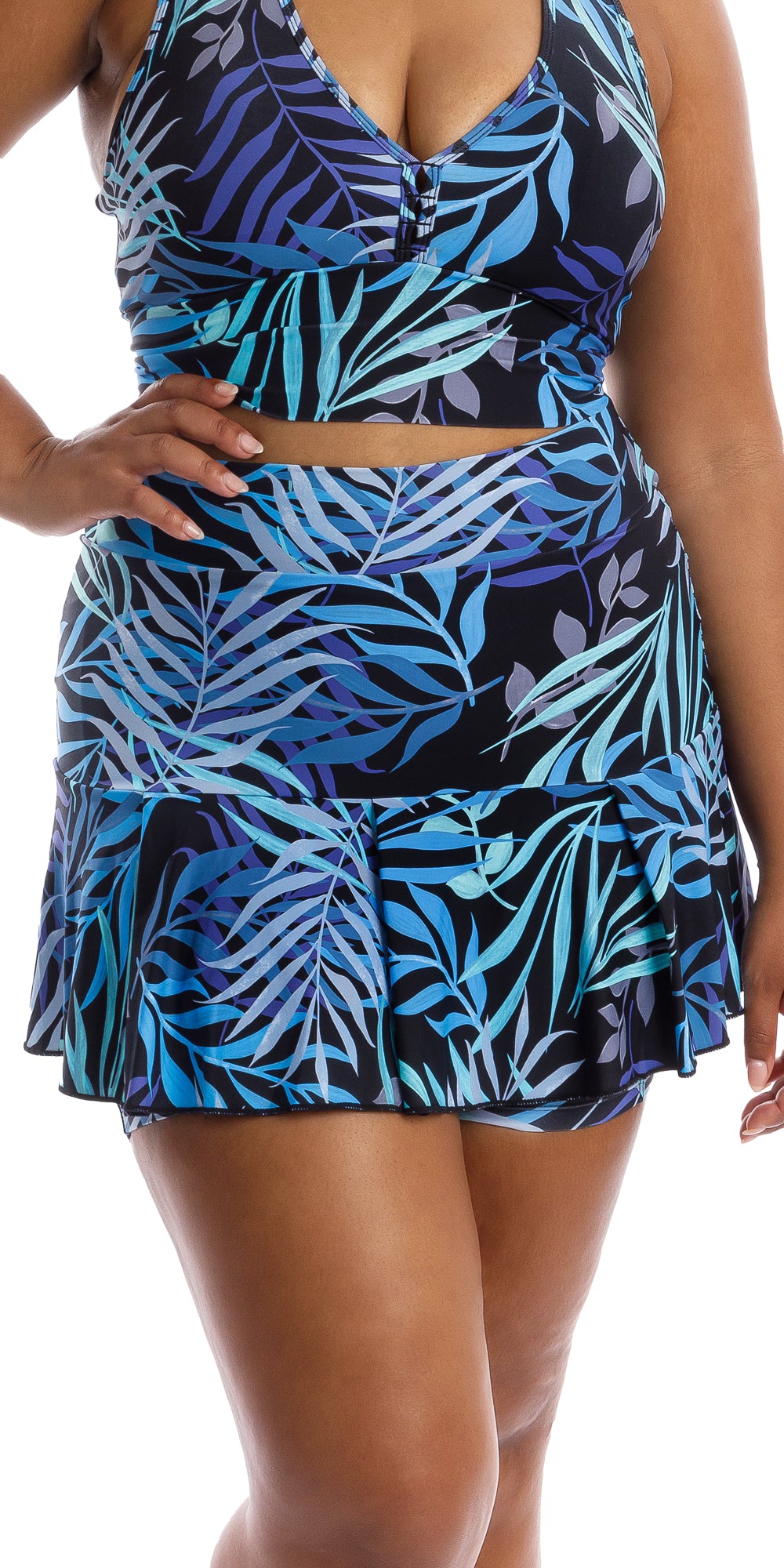 Front view of lady in blue and black Tropical Palm Skort and matching bra putting one hand on waist