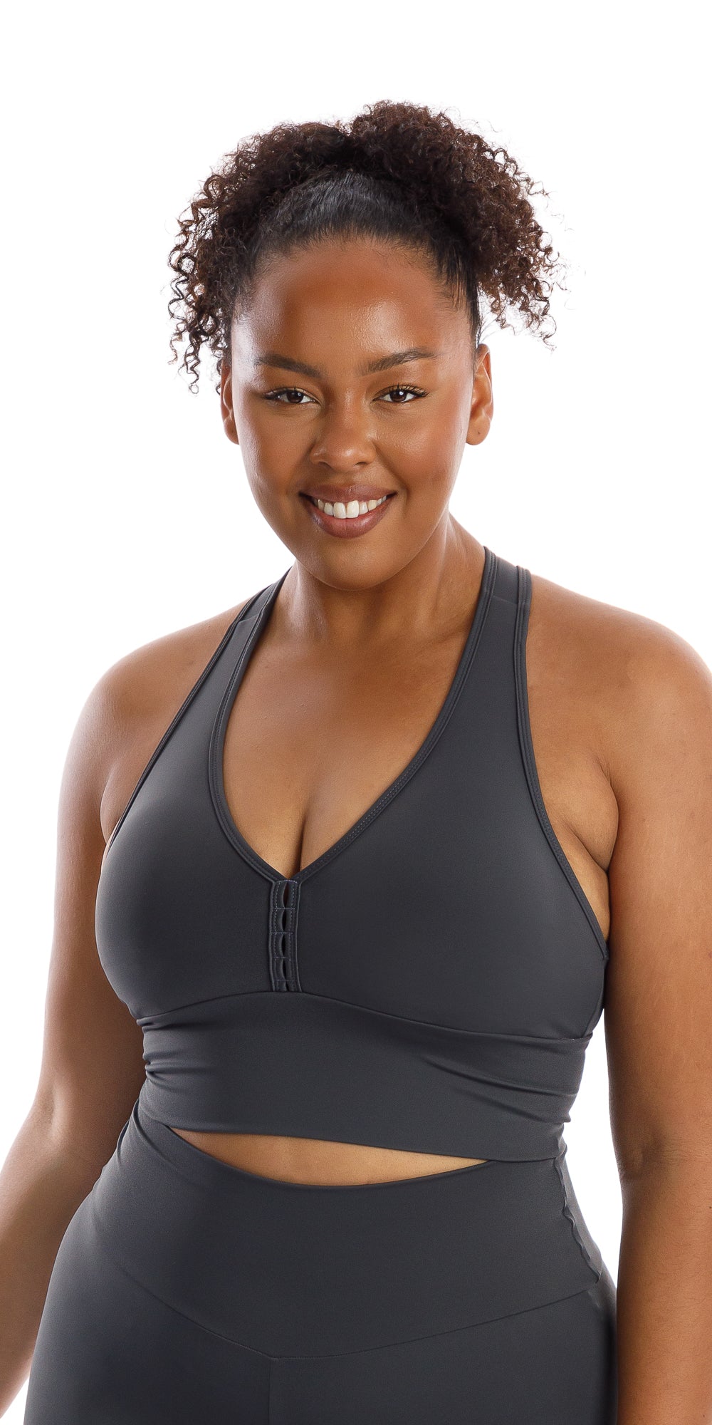 Front view of girl smiling and wearing grey Liquorice Body Luxe Racer Back Bra