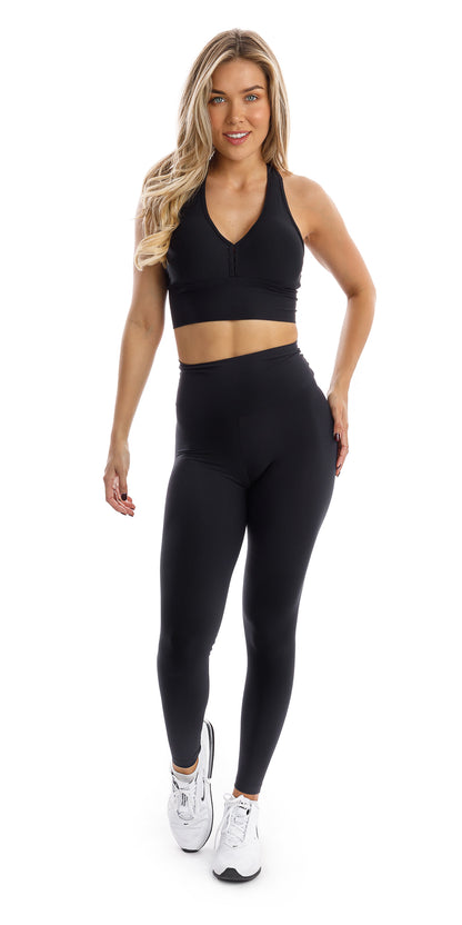 Full body front view of girl wearing black Midnight Eco Scrunch Bum Leggings and matching bra walking