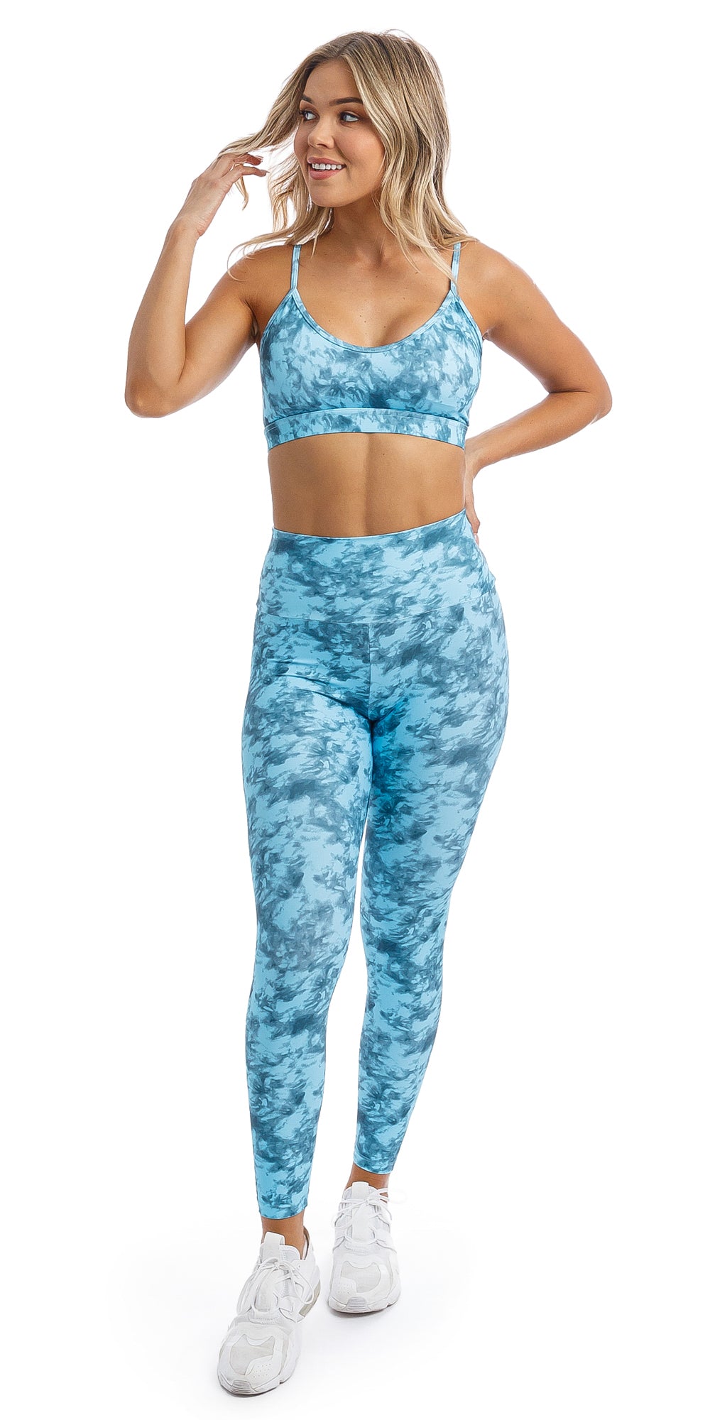 Front View of girl wearing blue tie dye blue crush print ultra high waist leggings & matching momentum bra