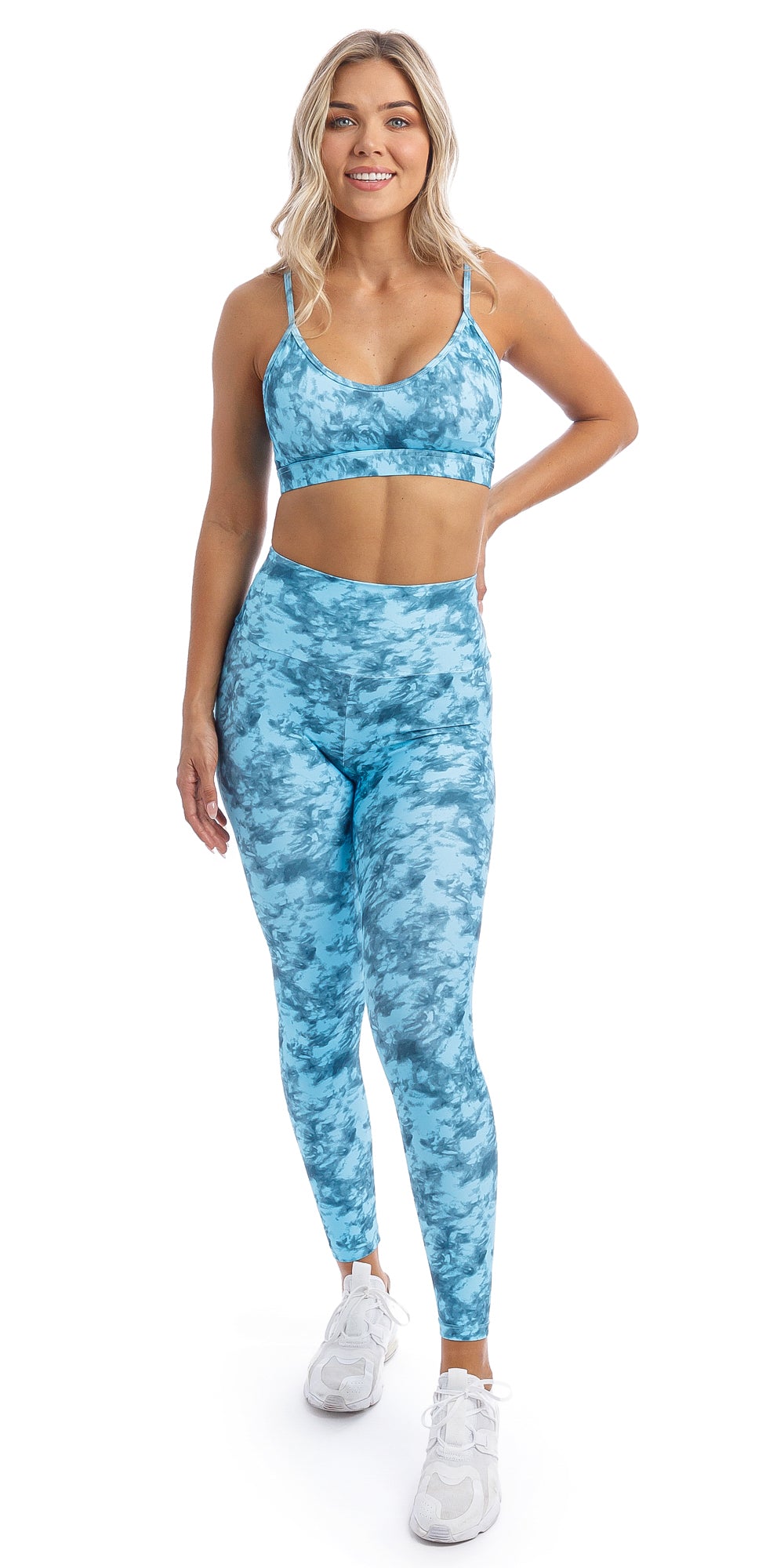 Front view of girl wearing blue tie dye blue crush print ultra high waist leggings & matching momentum bra