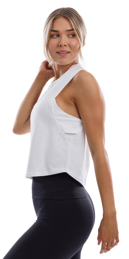Side view of girl wearing cropped white Burleigh Tank with side straps & matching ultra high waist midnight leggings