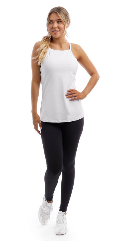 Full body front view of lady in strappy White Performance Tank and black leggings lifting right heel and putting left hand on waist while looking aside