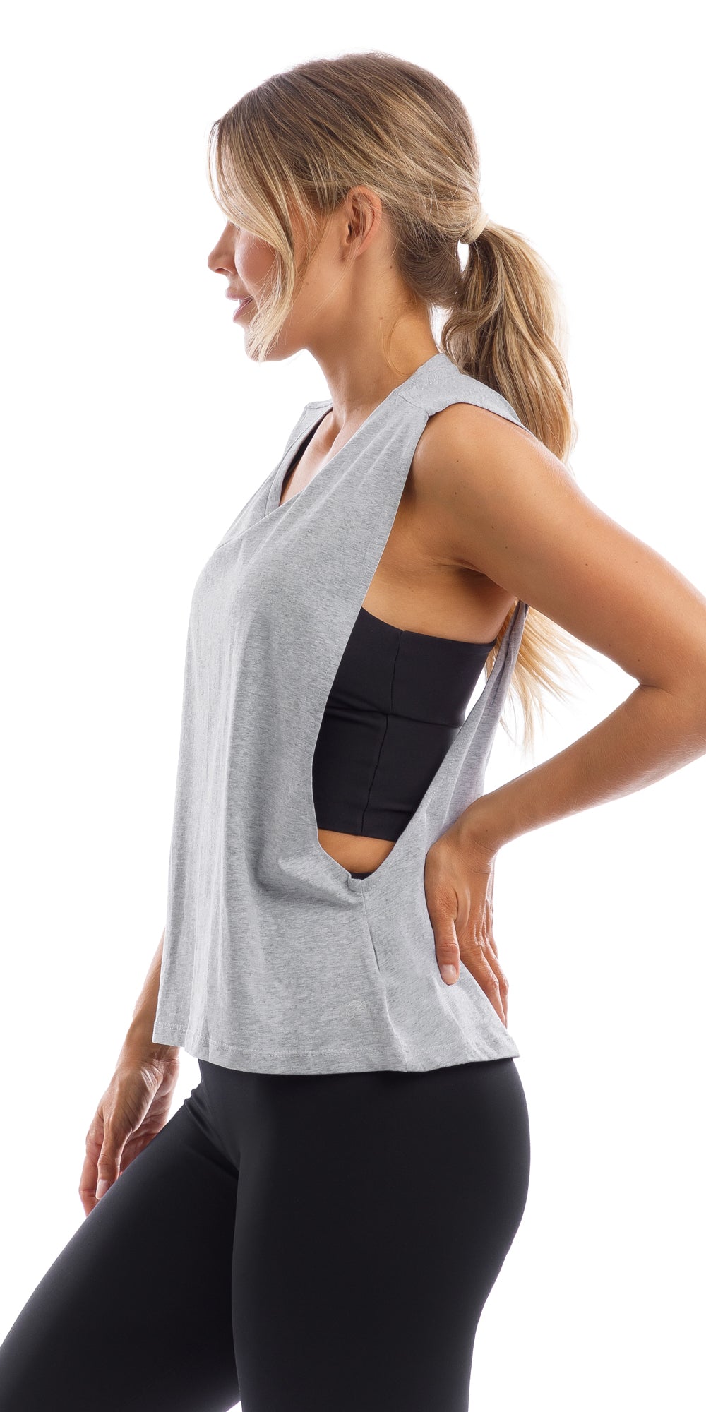 Side view of girl in grey Lennox Tank with open cut out back & ultra high waist midnight leggings