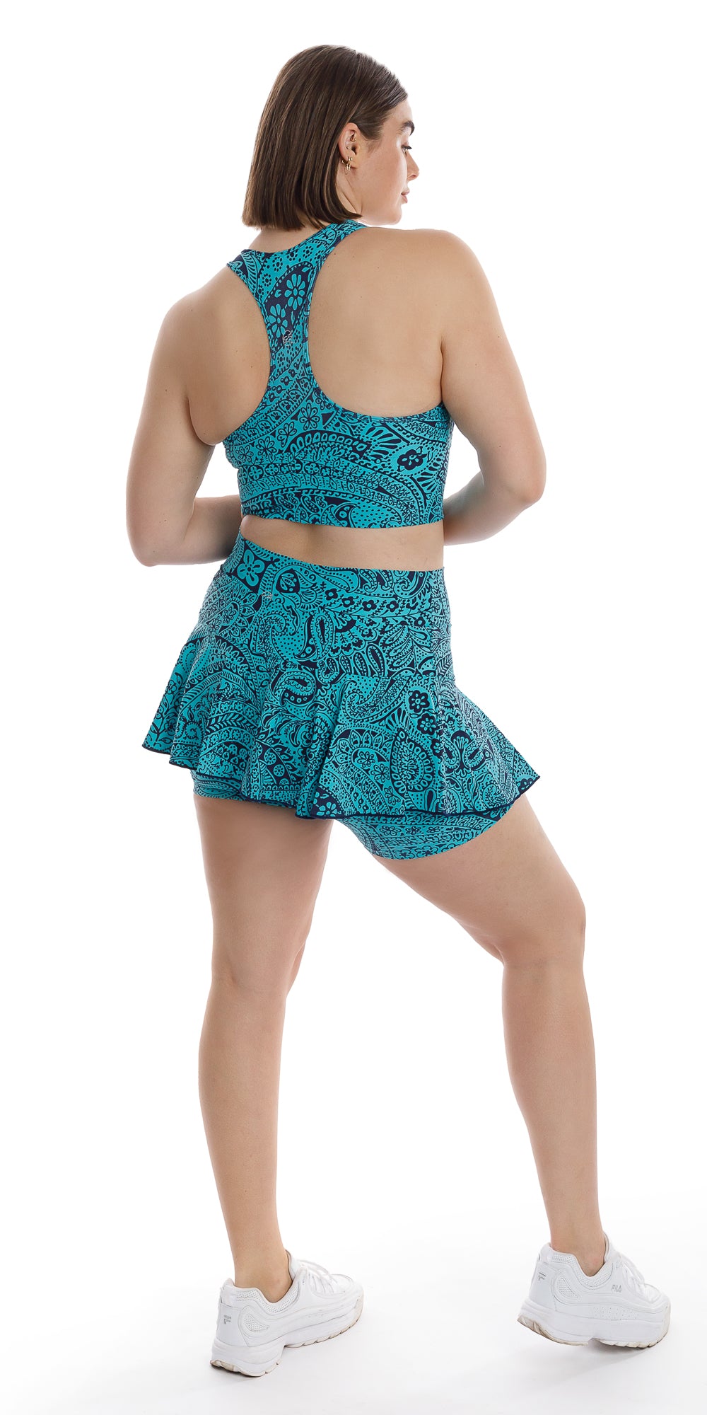Full body rear view of girl in aqua blue Paisley Tide Eco Racer Back Bra and matching skort