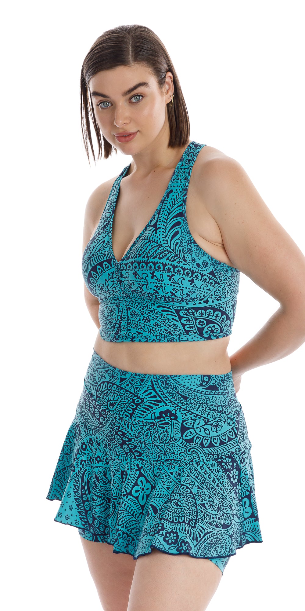 Front view of girl in aqua blue Paisley Tide Eco Racer Back Bra and matching skort