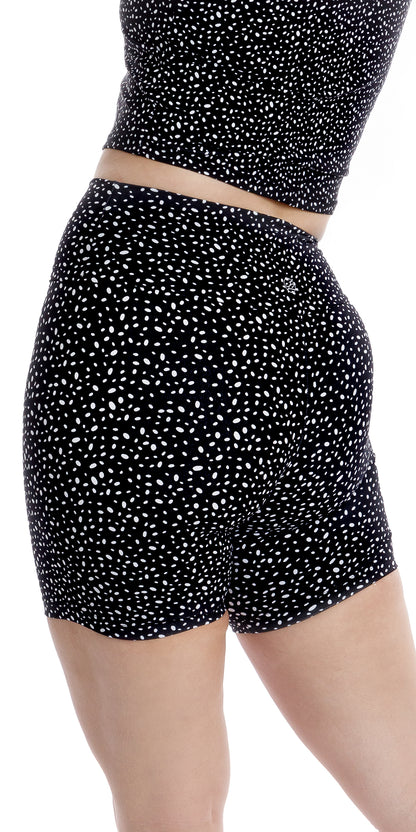 Rear view bottom part of girl wearing black Star Dust Body Luxe Midi Shorts and matching top